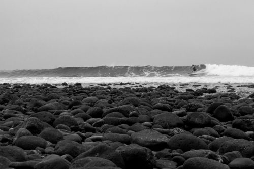 beach rocks surfer