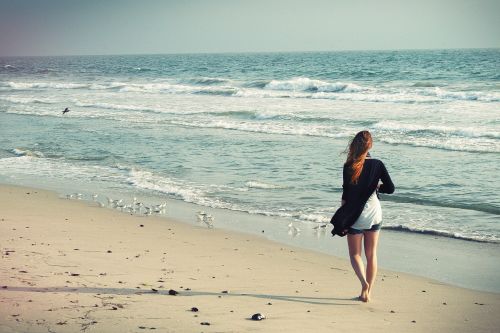 beach woman walking away woman walking away