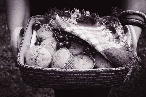 black and white muffins basket hands holding food basket