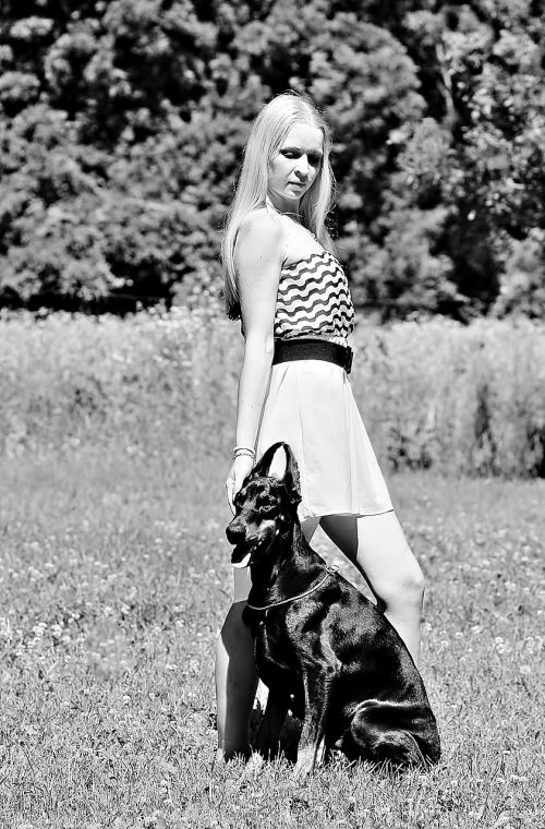 black white woman with a dog doberman