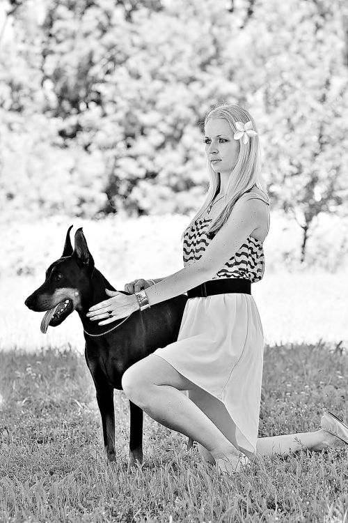 black white kneeling woman dogs