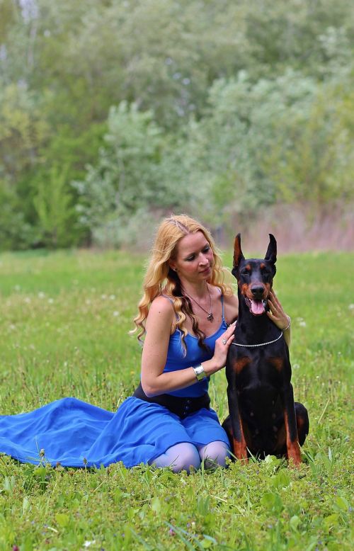 doberman woman and dog field