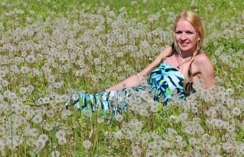 blonde woman dandelion field