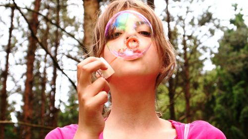 blow bubbles girl forest