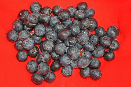Blue Berries On Red Cloth