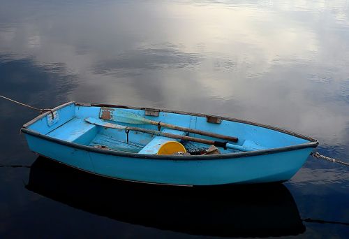 blue rowboat water calm
