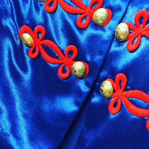 blue satin gold buttons costume uniform closeup