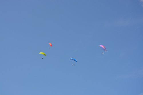 blue sky  paragliders  sails wings color multiple