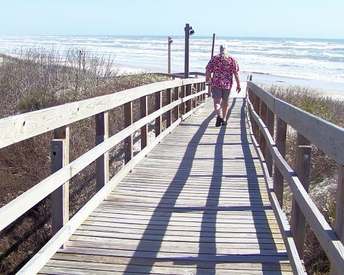 boardwalk beach lone walker