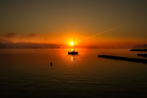 boat silhouette fog
