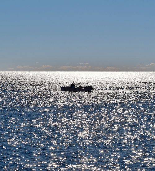 boat ocean sunlight
