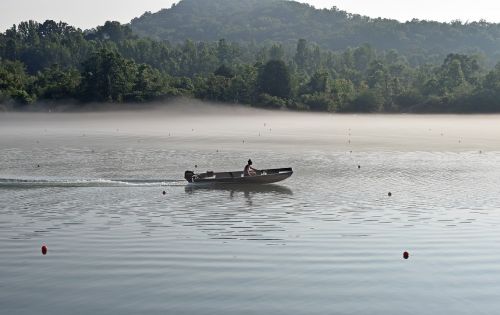 boater in fog early morning dawn