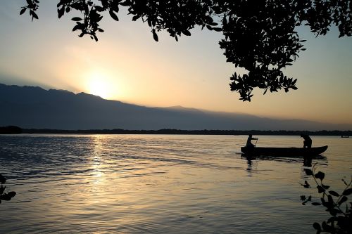 body of water sunset dawn