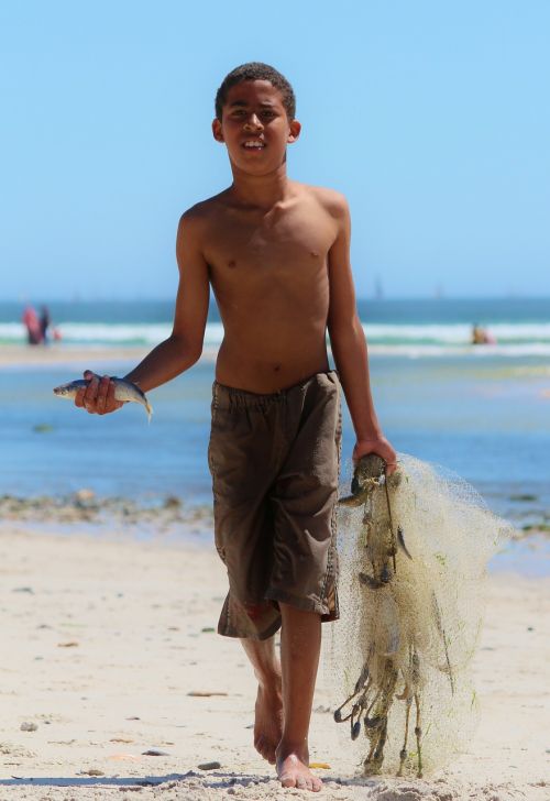 boy beach fish