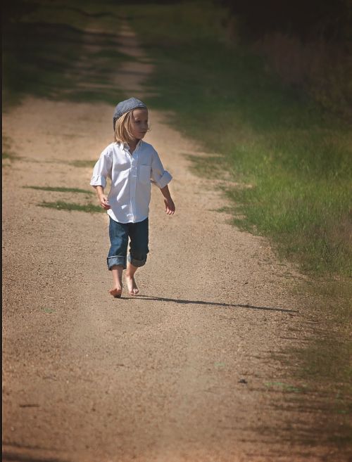 boy walking dirt road