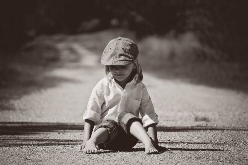 boy sitting road