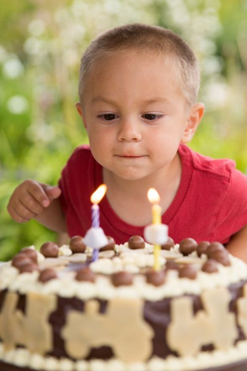 Boy Blowing Out Candles