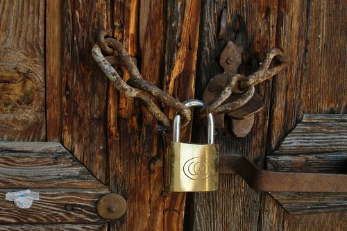 brass lock  padlock  rust chain