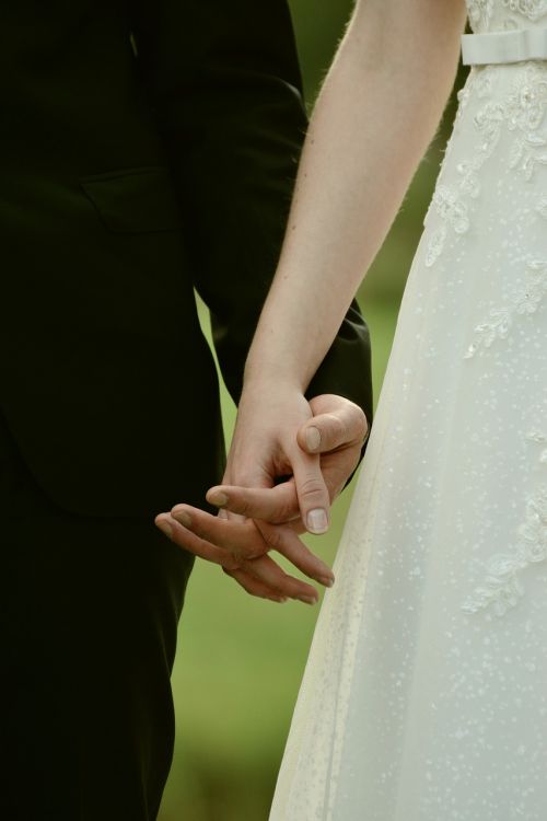 bride and groom hands together