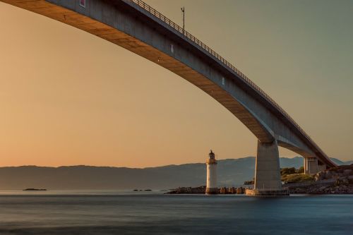 bridge lighthouse sunset