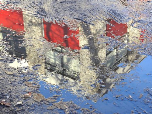 Building Reflection In Puddle