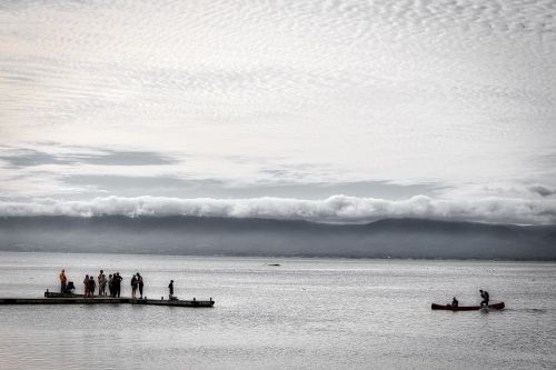 canoe clouds water