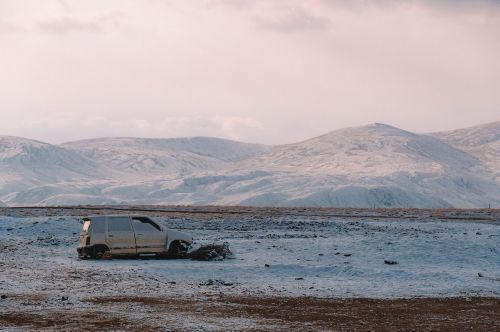 car abandoned desert snow
