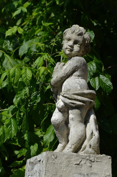 cherub statue greenery