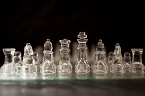 chess pieces glass chessboard