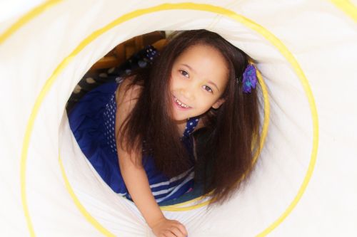 child girl crawling tunnel