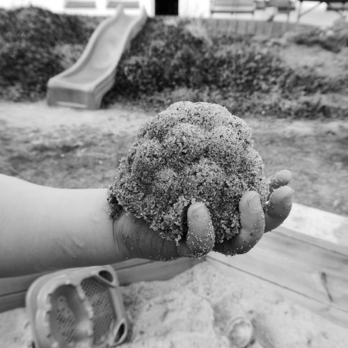 child hand sand