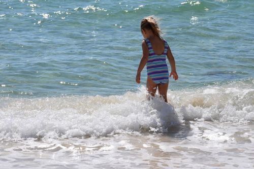 child in the surf child swim