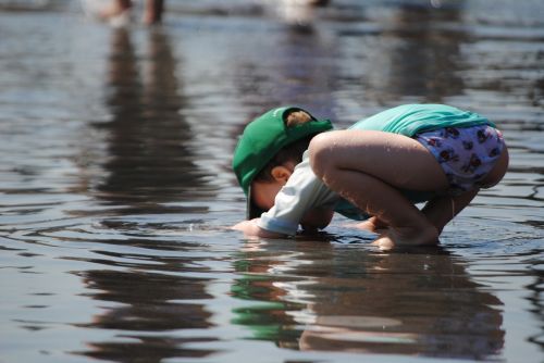 child playing in water toddler in summer child