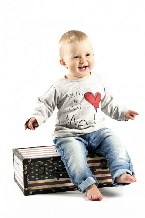 Child Sitting On The Suitcase