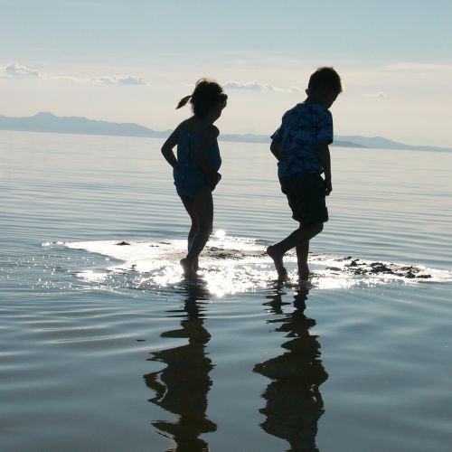 children walking water