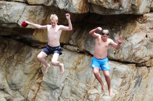 children jump rock