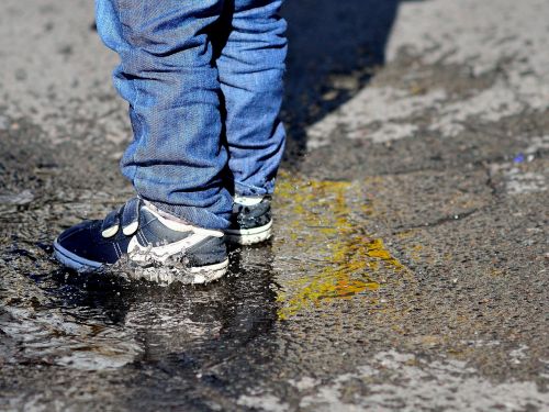 children's feet puddle splash