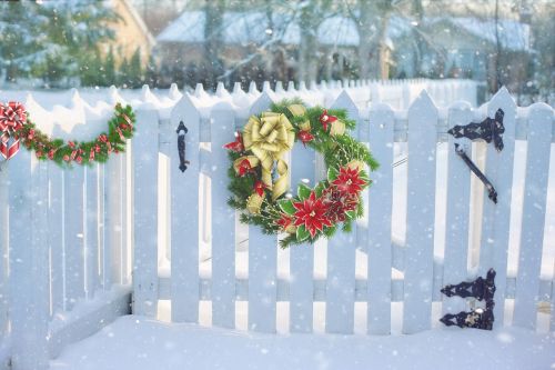 christmas wreath on fence fence snow