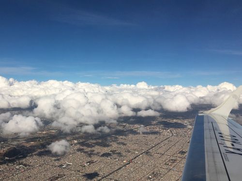 cloud over city flight wing