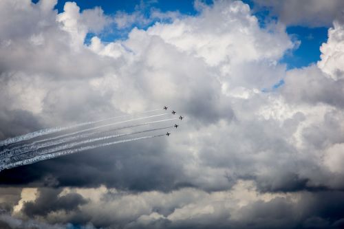 clouds blue sky red arrows