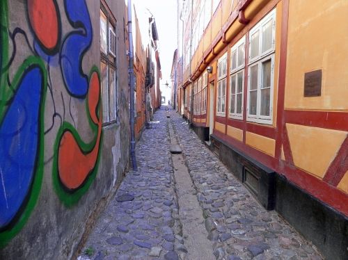 cobblestone street narrow street graffiti