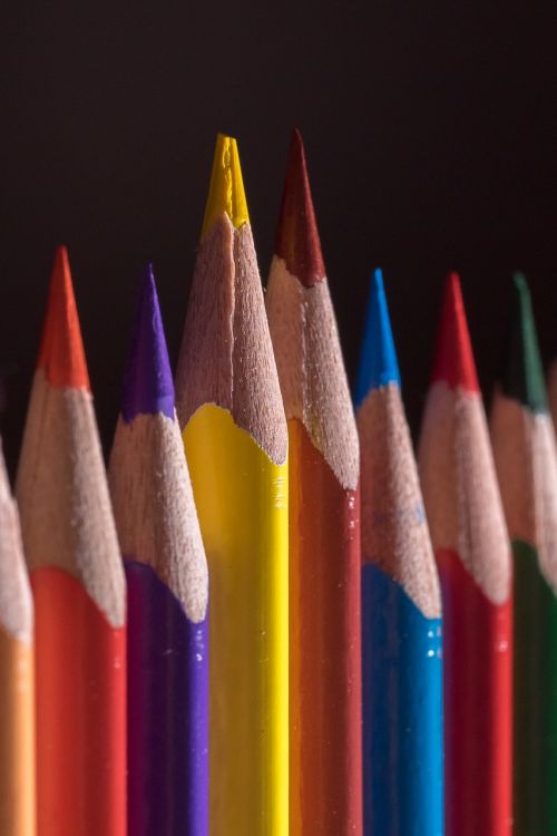 colored pencils wooden pegs pens