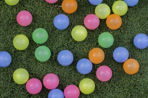 colorful balls on grass field balls grass