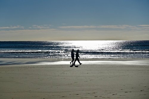 couple  stroll  beach