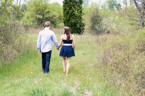 couple hand holding walking