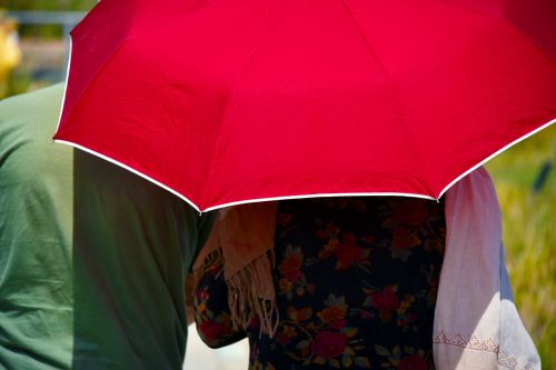 Couple Under Red Umbrella