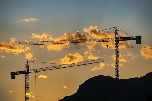 cranes  sky  sunset