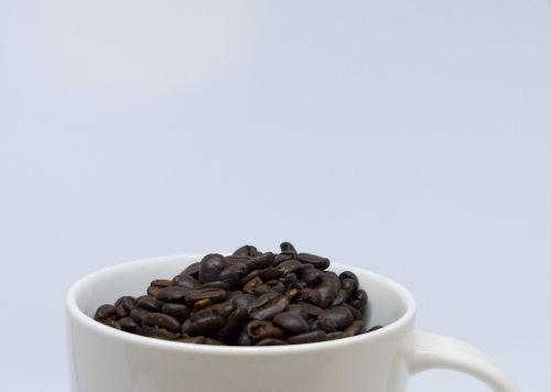 Cup Brimming With Coffee Beans