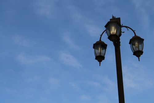 early in the morning street lamp blue sky