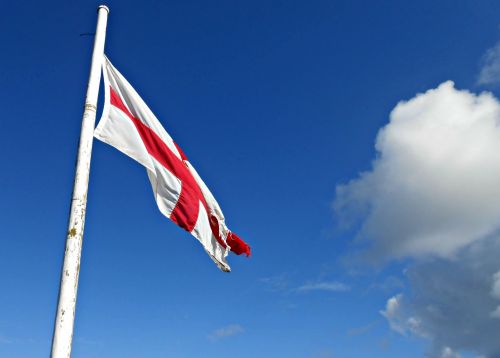 England Flag Against Blue Sky